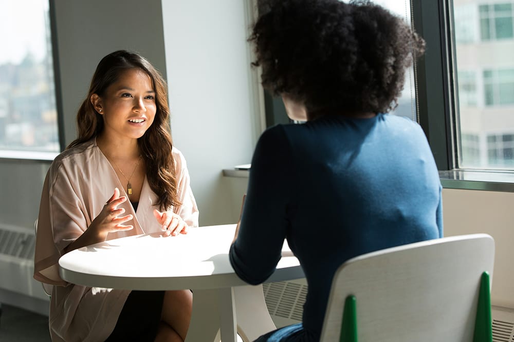 two women talking at work